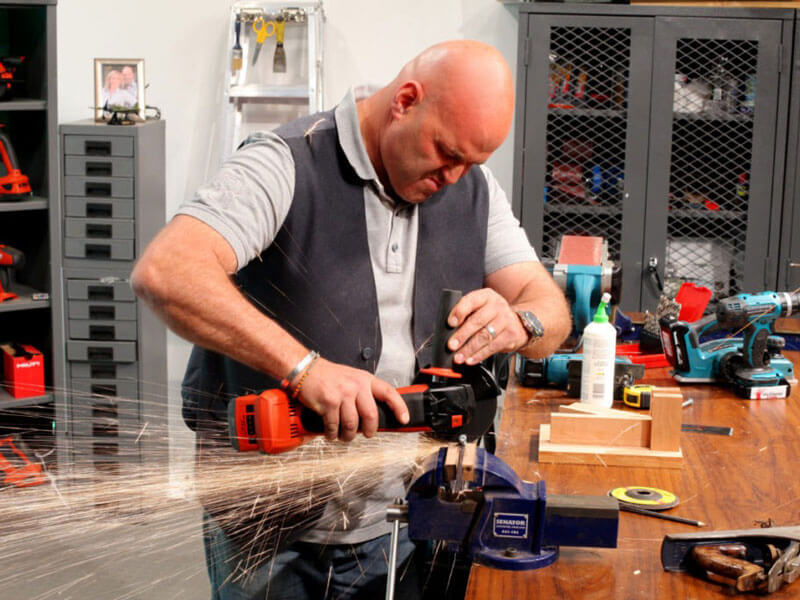 man grinding tool on fabricator