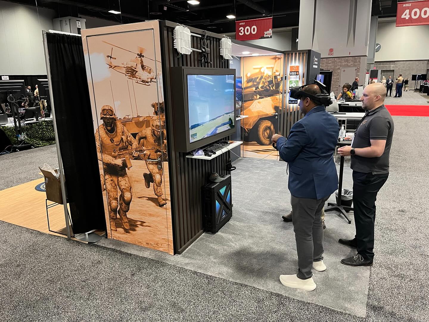 Men using virtual reality at a trade show booth