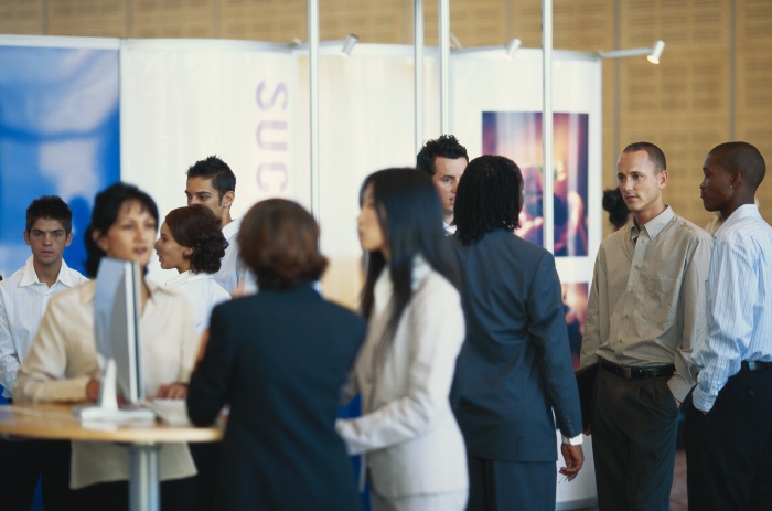 Executives attending a business expo in an exhibition center