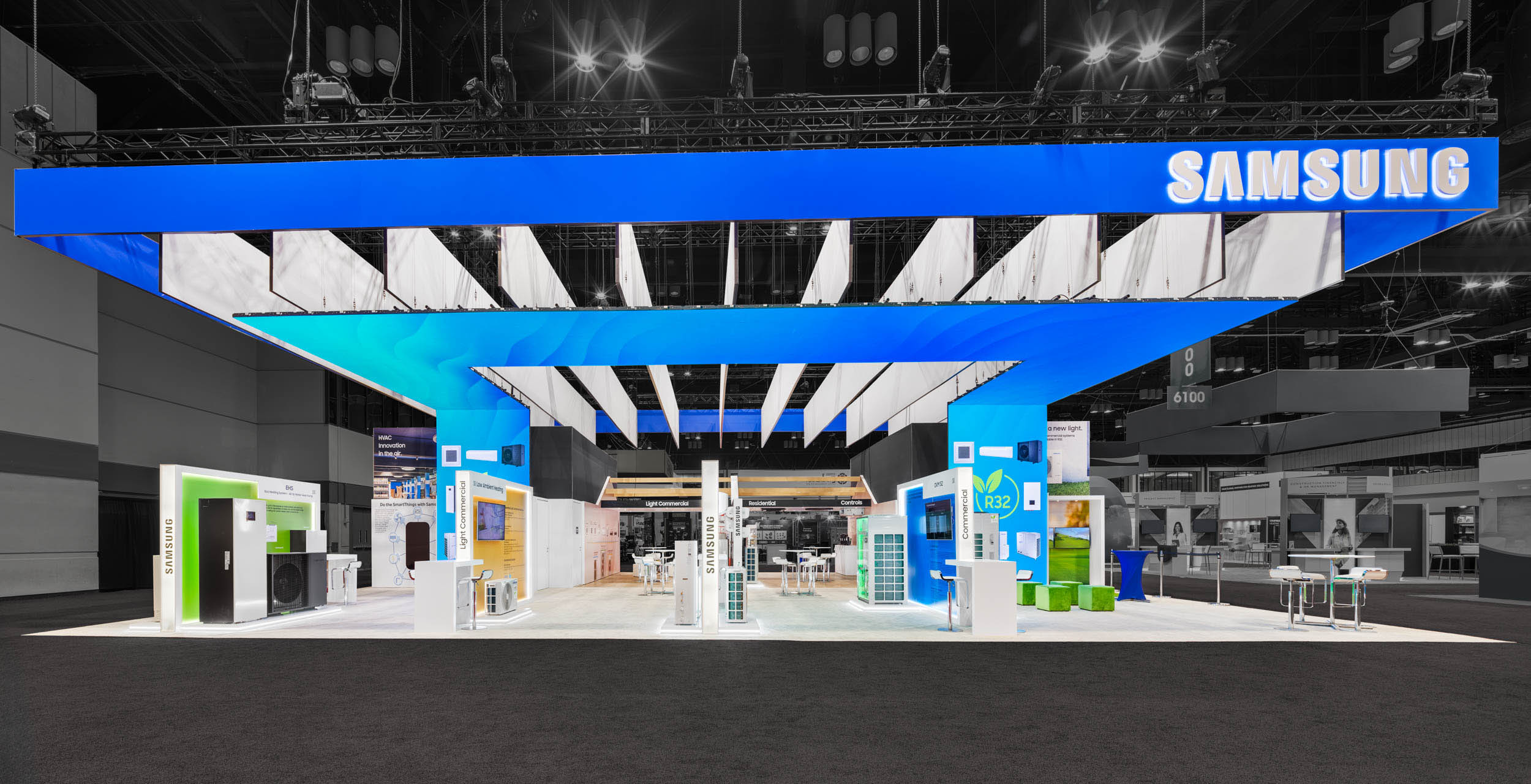 Backlit trade show booth display with large illuminated graphics and interactive product showcases