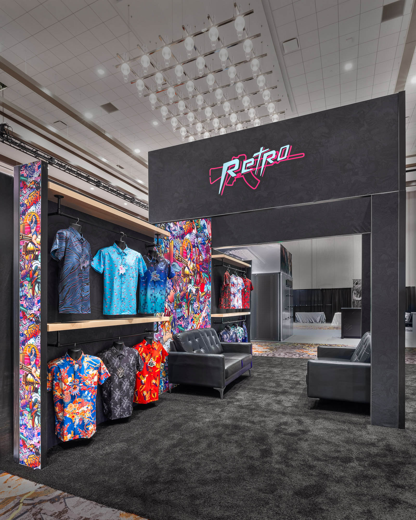 Custom trade show booth with vibrant branded graphics, product displays, and attendee lounge